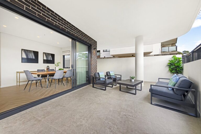 Covered alfresco terrace with outdoor lounge and dining setting at LaCurva