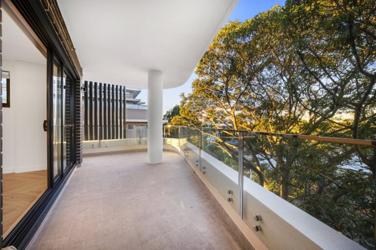 Balcony with glass balustrade looking out to mature trees at LaCurva
