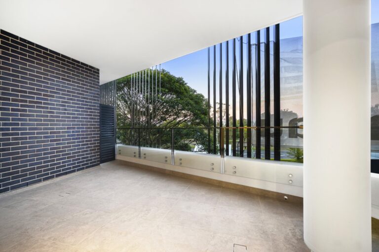 Balcony with face brick wall, glass balustrade and vertical screens at LaCurva