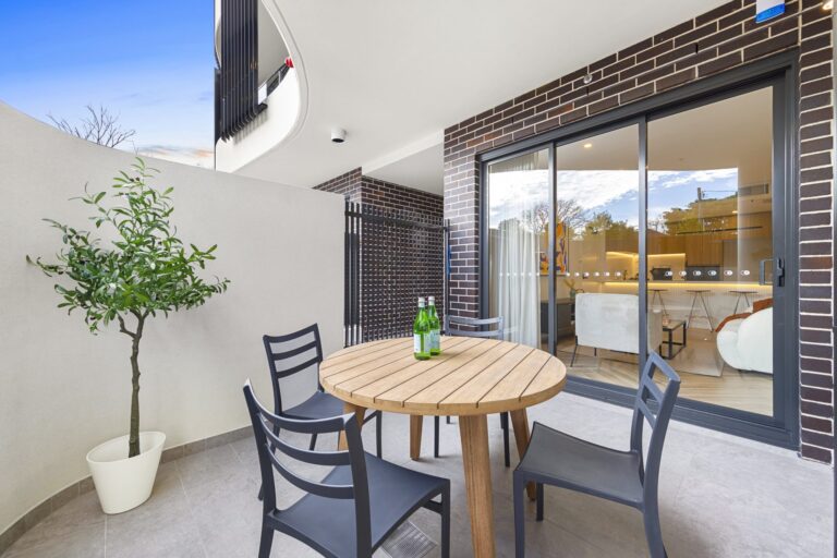 Private courtyard with outdoor table setting beside sliding doors at LaCurva